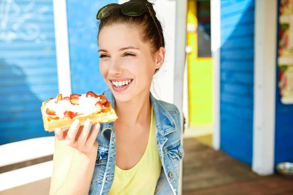 Girl eats waffles with whipped cream and strawberries — Stock Photo, Image