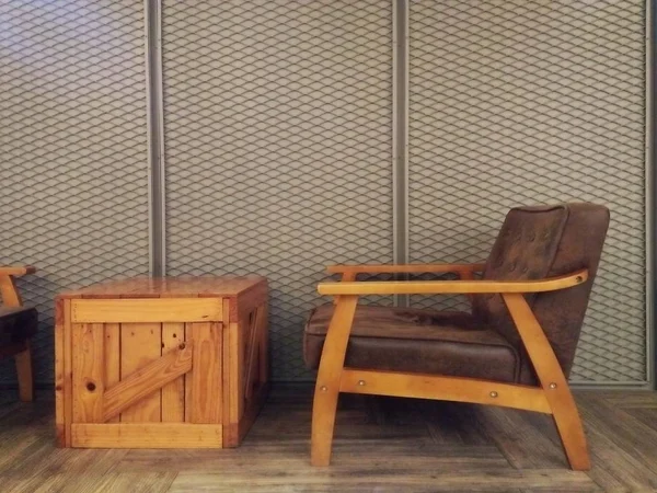 Vintage pallets wood desk and brown leather cushion on wooden sofa with iron material modern gray wall; Interior design of living room.