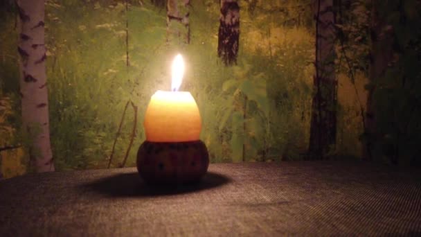 Yellow Egg Shaped Candle Lit Wood Background — Stock Video