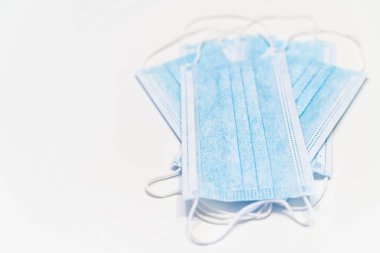 Protective medical face mask on white background, virus protection. Isolated and copy space color image.