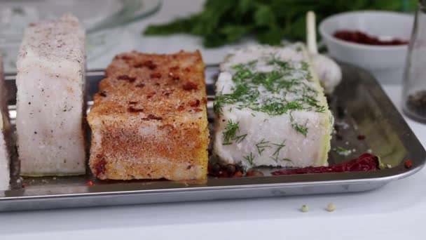 Four kinds of different salty bacon lie in a metal tray, close-up — Stock Footage Four Kinds Different Salty Bacon Lie Metal Tray Close Stock Footage