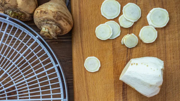 Chopped pieces of root parsnip lie on a cutting board