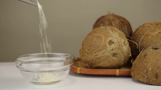 Grated Coconut Shavings Sprinkled Transparent Glass Bowl Side View — Stock Video