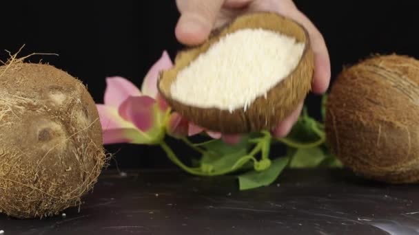 Female Hand Pours Grated Coconut Shell Black Surface Close — ストック動画