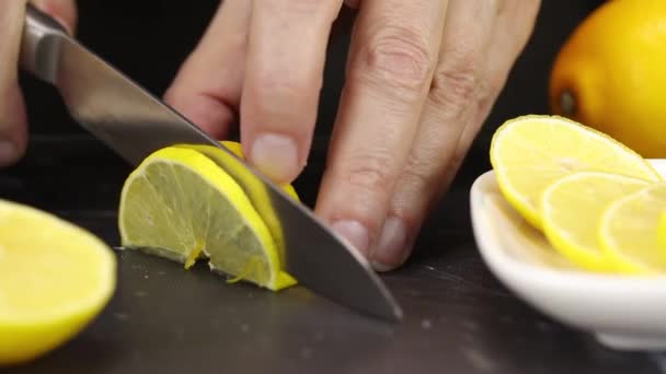 Female Hand Cuts Half Lemon Half Rings — Stock Video