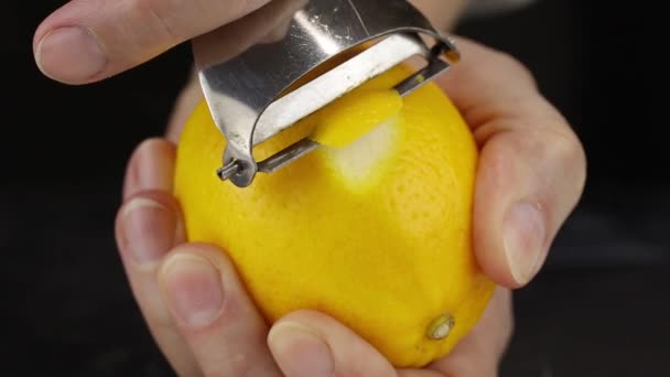 Female Hand Peels Lemon Peeler — Stock Video