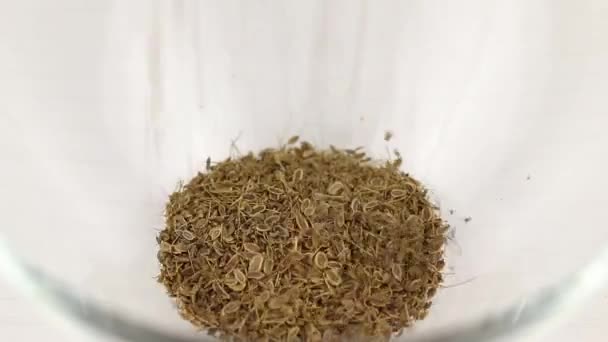 Dill Seeds Fall Transparent Glass Bowl Close — Stock Video