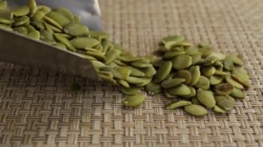 Balkabağı çekirdekleri metal kepçesinden düşer.