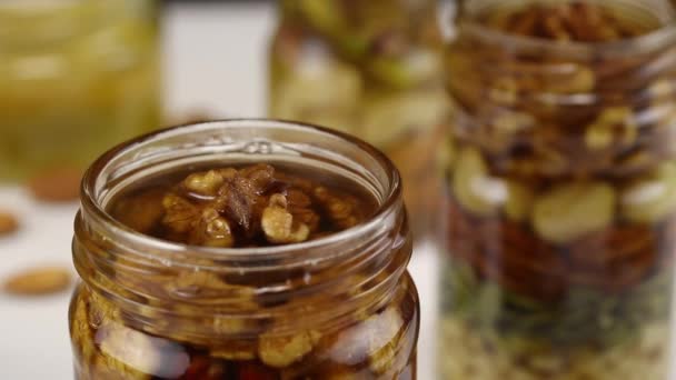 Honey Flows Glass Jar Mixture Nuts Close — Stock Video