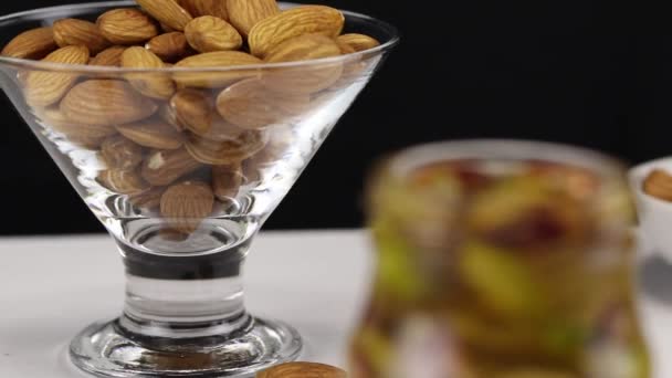 Focus Translation Glass Transparent Bowl Almonds Glass Jar Cashew Nuts — Stock Video