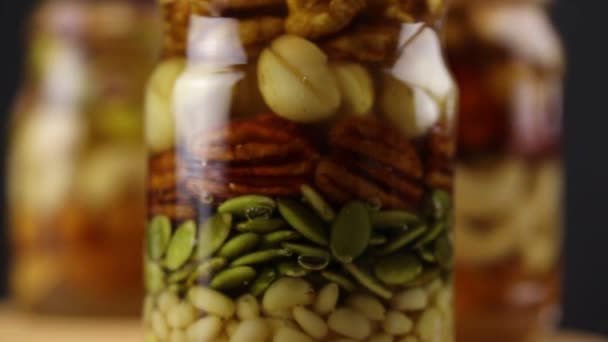 Glass Jars Nuts Seeds Honey Rotate Clockwise Side View Close — Stockvideo