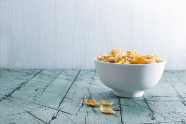 Yulaf ve Mısır gevreği beyaz kase üzerinde 