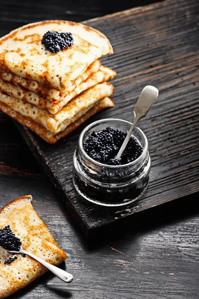 Pancakes with black caviar — Stock Photo, Image