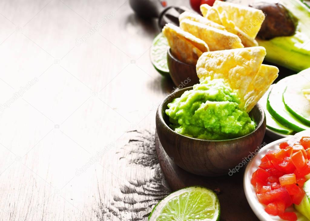Guacamole on wooden table. 