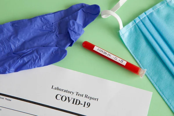 World coronavirus epidemic concept. Pandemic COVID-19, 2019-nKoV. Coronavirus vaccine testing. Positive analysis and laboratory blood sample. Test tube, vaccine, mask.