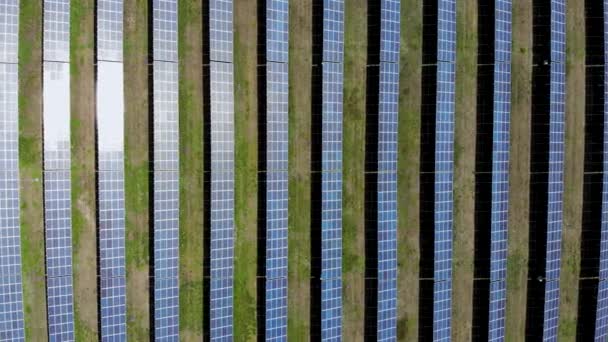 Survol aérien d'une centrale solaire. La lumière du soleil est réfléchie des panneaux solaires 