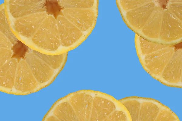 Sliced lemon on a blue background, concept for recipes, blog or cookbook