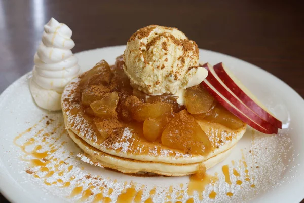 Japanese pancake homemade with pineapple and apple topping with vanilla ice-cream on white plate. Dessert pancake.