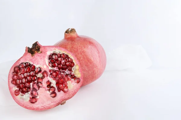 Juicy pomegranate and its half. Separately on a white background. — Stock Photo, Image