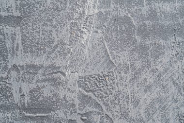 Arka plan beton dokusu, bir sürü çizik, boya lekesi ve çıkıntısı var. gri renk.