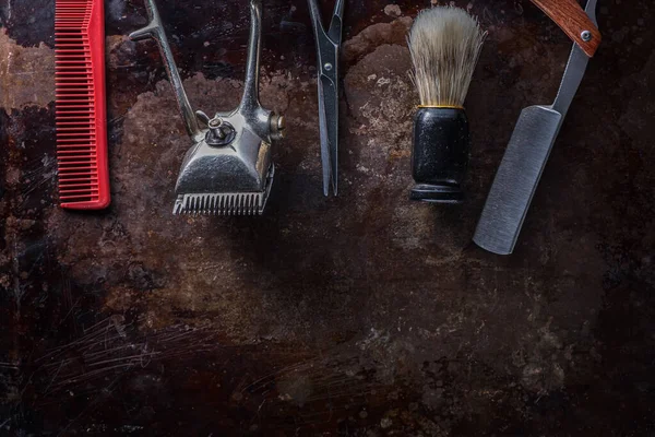 Old barber tools on an old beautiful rusty surface.