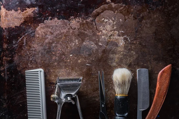 Old barber tools on an old beautiful rusty surface.