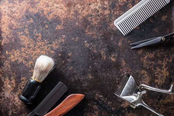 Old barber tools on an old beautiful rusty surface.