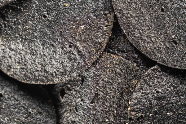 Fundo de muitos chips pretos com especiarias — Fotografia de Stock