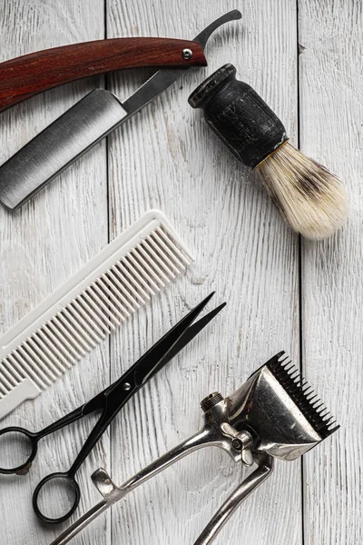 vintage barber tools dangerous razor hairdressing scissors old manual clipper comb shaving brush. vertical