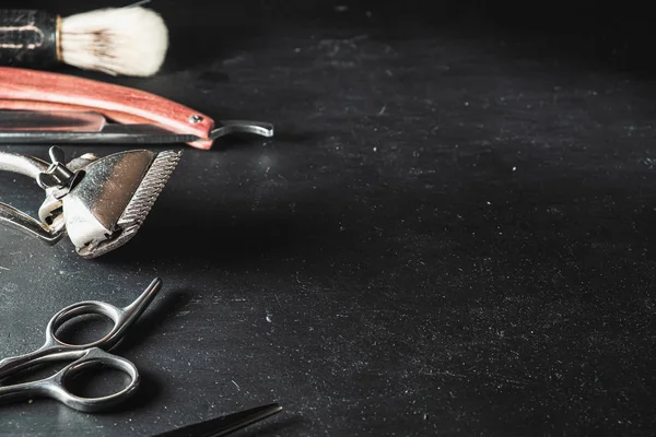 stock image vintage Barber shop equipment on Black background . Professional hairdressing tools. scissor, manual hairclipper, razor, shaving brush. copy space