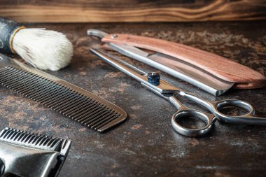vintage barber tools dangerous razor, hairdressing scissors, old manual clipper, metal comb, shaving brush. old rusty metal background. Horizontal. clipart