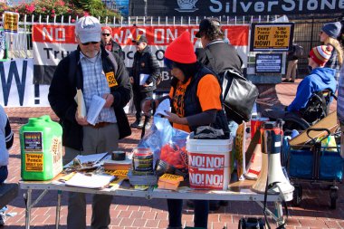 San Francisco, CA - Jan 11, 2020: Unidentified people protesting the Trump Pence presidency, demanding No War in Iran. Handing out flyers preparing to march in the streets.