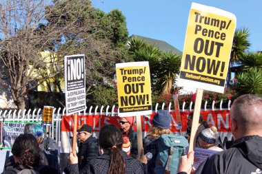 San Francisco, CA - Jan 11, 2020: Unidentified people protesting the Trump Pence presidency, demanding No War in Iran. Marching in the streets downtown blocking traffic.