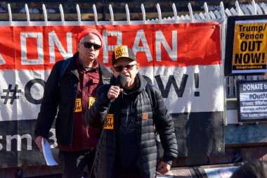San Francisco, CA - Jan 11, 2020: Unidentified people protesting the Trump Pence presidency, demanding No War in Iran. Marching in the streets downtown blocking traffic.