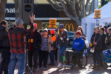 San Francisco, CA - Jan 11, 2020: Unidentified people protesting the Trump Pence presidency, demanding No War in Iran. Marching in the streets downtown blocking traffic.