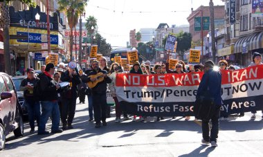 San Francisco, CA - Jan 11, 2020: Unidentified people protesting the Trump Pence presidency, demanding No War in Iran. Marching in the streets downtown blocking traffic.