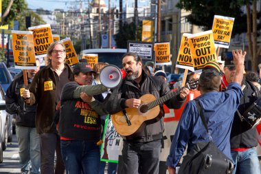 San Francisco, CA - Jan 11, 2020: Unidentified people protesting the Trump Pence presidency, demanding No War in Iran. Marching in the streets downtown blocking traffic.