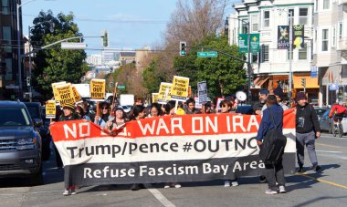 San Francisco, CA - Jan 11, 2020: Unidentified people protesting the Trump Pence presidency, demanding No War in Iran. Marching in the streets downtown blocking traffic.