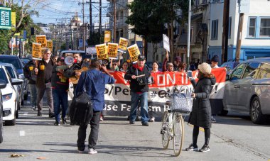 San Francisco, CA - Jan 11, 2020: Unidentified people protesting the Trump Pence presidency, demanding No War in Iran. Marching in the streets downtown blocking traffic.