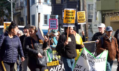 San Francisco, CA - Jan 11, 2020: Unidentified people protesting the Trump Pence presidency, demanding No War in Iran. Marching in the streets downtown blocking traffic.