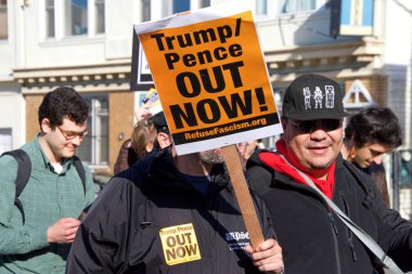 San Francisco, CA - Jan 11, 2020: Unidentified people protesting the Trump Pence presidency, demanding No War in Iran. Marching in the streets downtown blocking traffic.