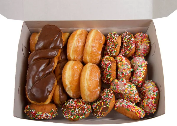 Large box with various donuts. Cake with sprinkles, glazed and chocolate covered twists, and basic glazed donuts. A popular american junk food.