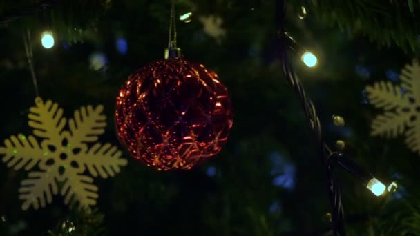 Christmas fir tree with decorations in street — Stockvideo