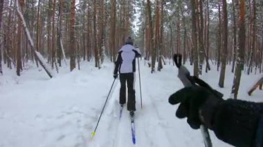 Ormanda yürüyen tanınmayan kayakçılar. Birinci şahıs görünümü