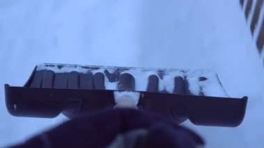 Person with shovel remove snow from yard