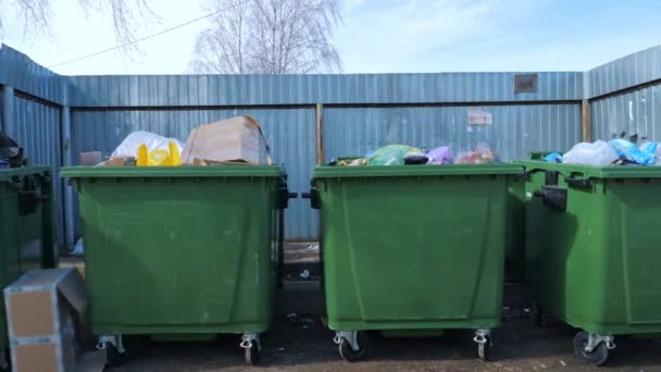 Waste bins near metal fence — Stock Video