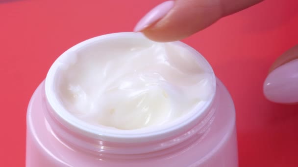 Woman takes finger cream from a pink jar. Close up — Stock Video