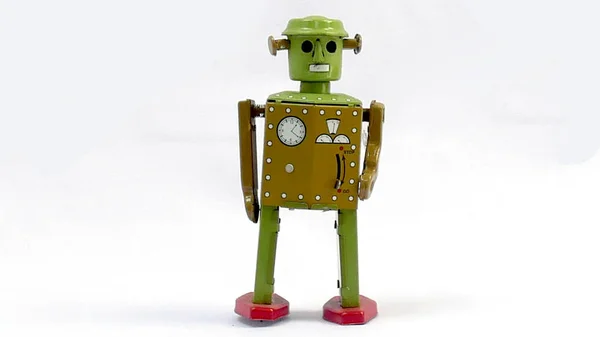 Vintage tin robot toy isolated on a white background.