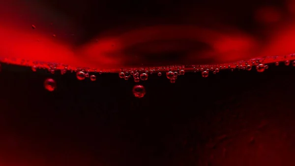 Red water bubbles on black background.
