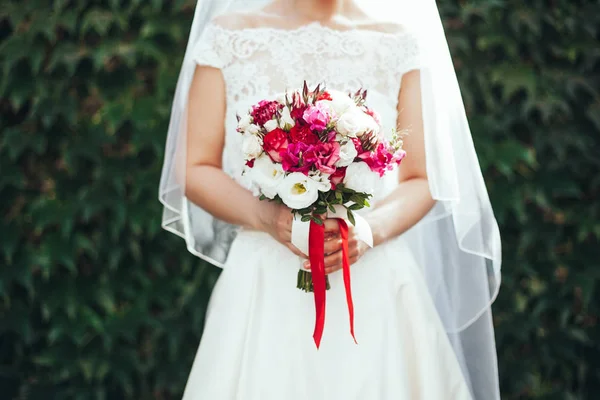 Matrimonio. La sposa in un vestito in piedi in un giardino verde e alcol — Foto Stock